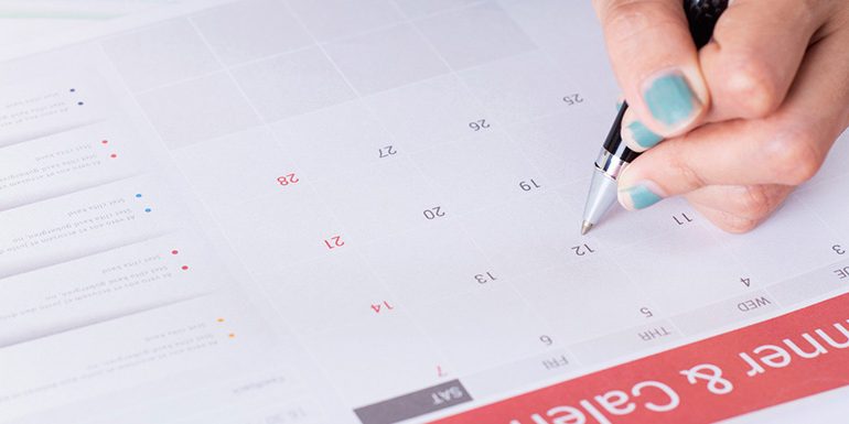 scheduling Business people using pen,tablet,notebook are planning a marketing plan to improve the quality of their sales in the future.